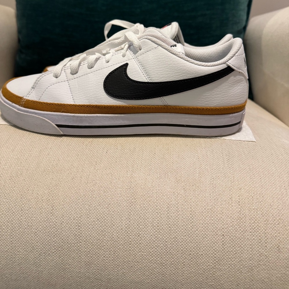 Nike White Sneakers with Black Swoosh and Gold Trim